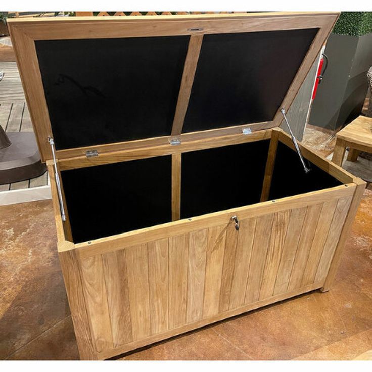 an open wooden box sitting on top of a table