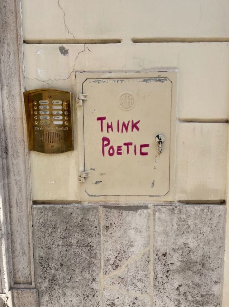 a sign on the side of a building that says think petic