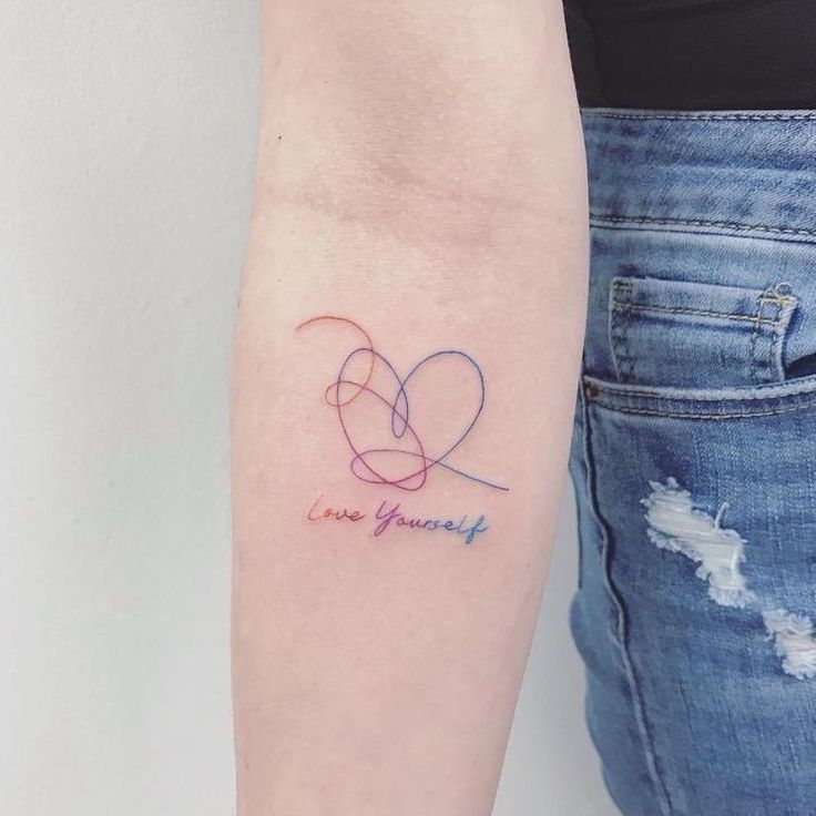 a woman's arm with a tattoo that says love yourself on the left side of her arm