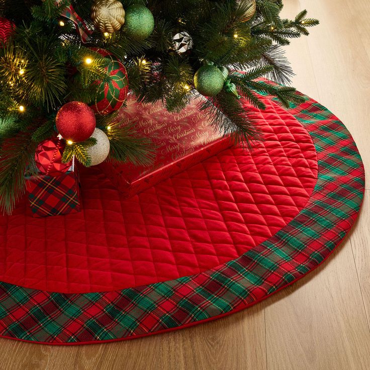 a christmas tree skirt with presents under it