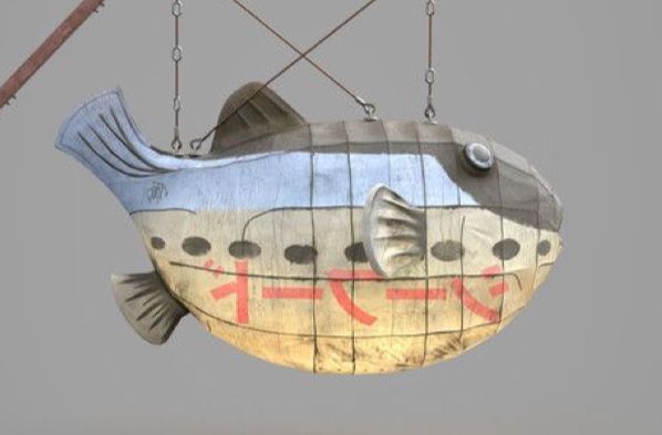 a fish shaped lantern hanging from a wire