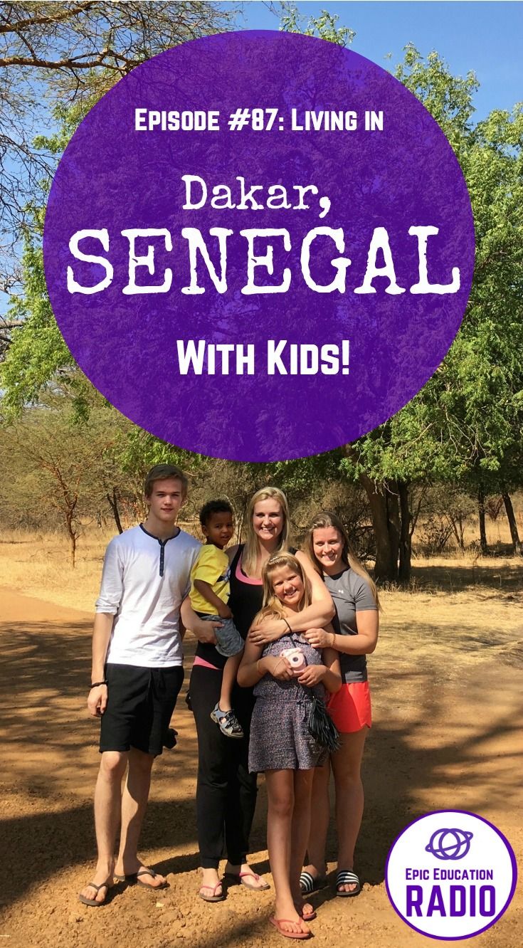 the family is posing for a photo in front of some trees with an oval sign that says