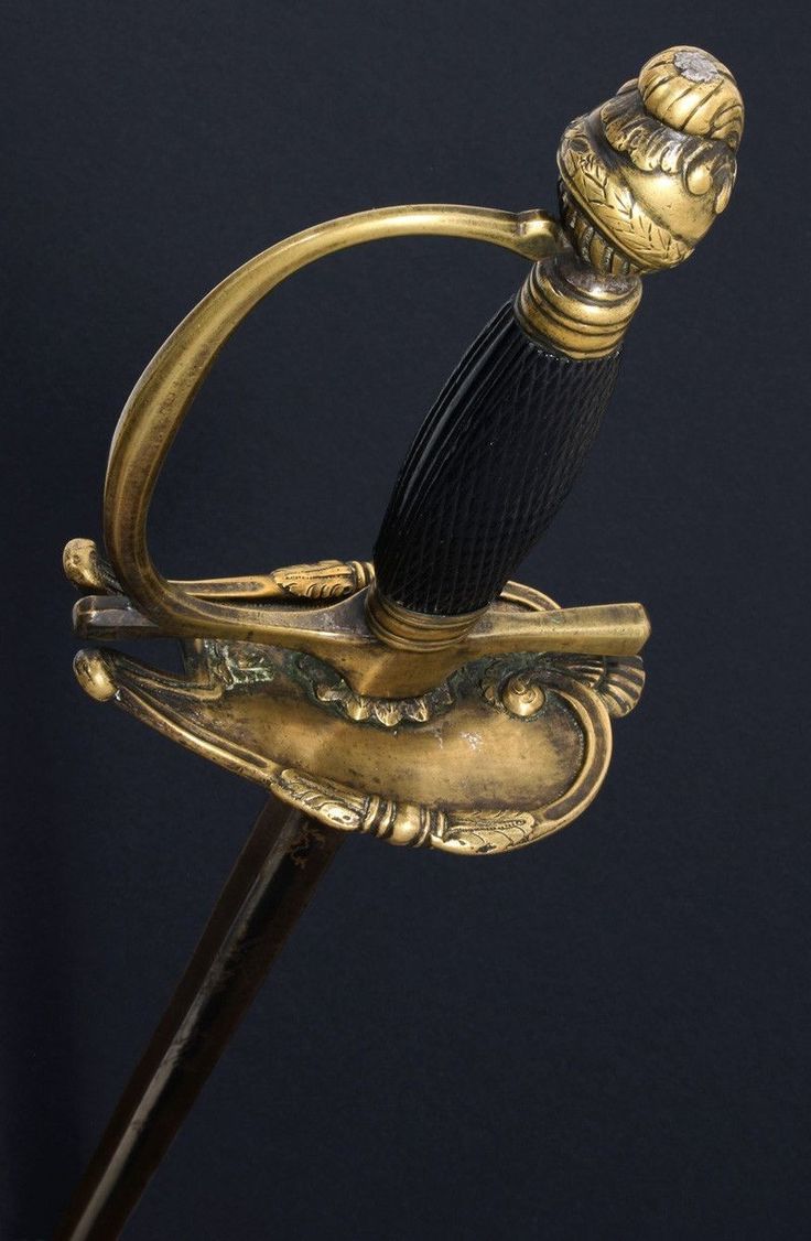 an ornate gold and black handle on a cane