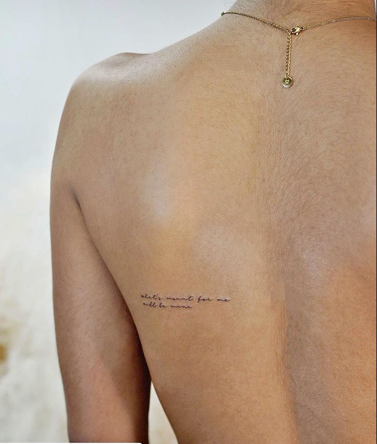 the back of a woman's shoulder with writing on it