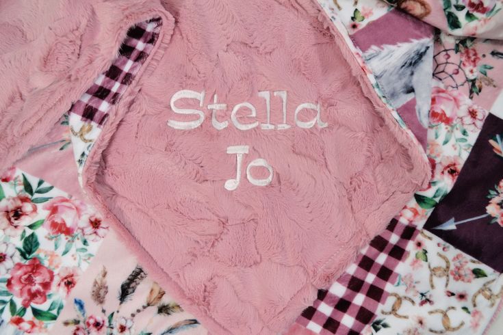 a pink blanket with the word stella jo written on it