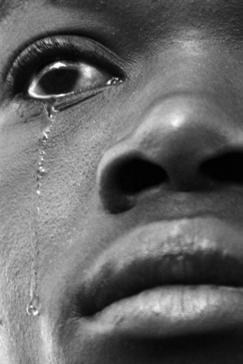 a close up of a person with tears on their face