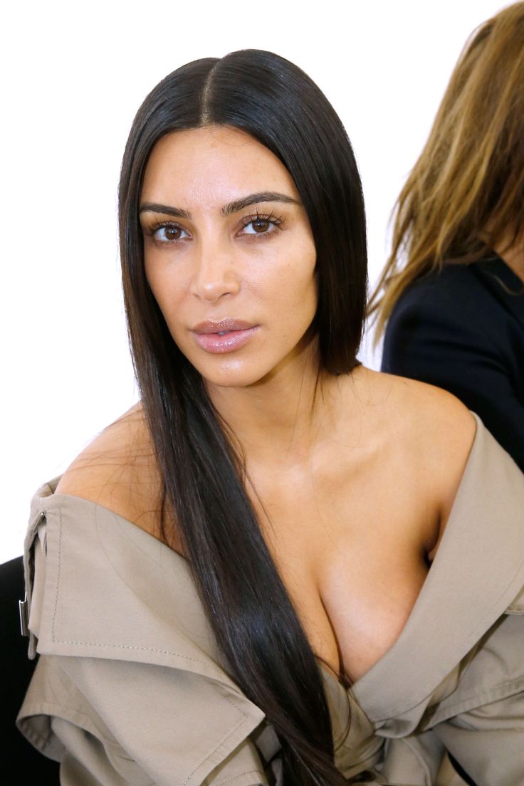 an image of a woman with very large breast and long dark hair posing for the camera