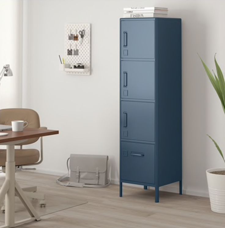 a tall blue cabinet sitting next to a wooden table