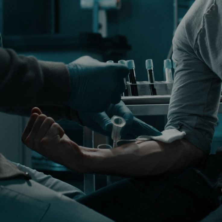 a man getting his arm examined by a doctor in an operating room at the hospital