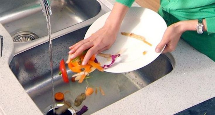 a woman is cutting up vegetables on a plate in the kitchen with a water faucet