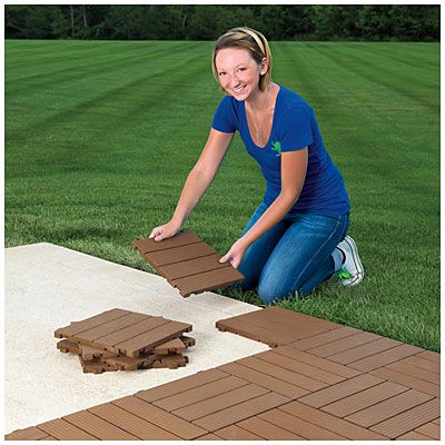 a woman kneeling on the ground next to a piece of wood that has been cut into pieces