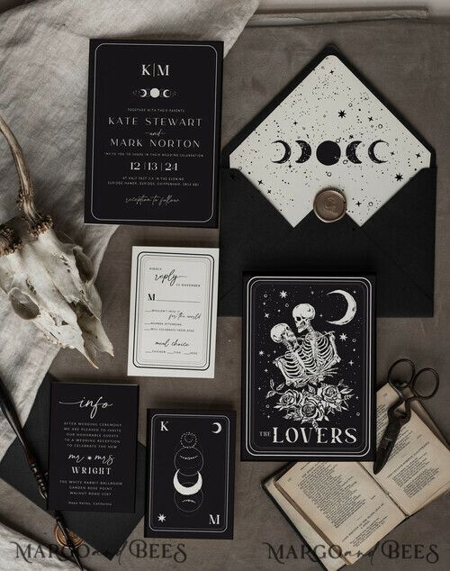 the wedding stationery is laid out on top of an old book and some other items