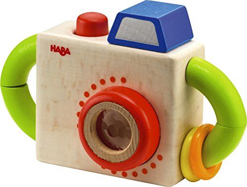 a wooden toy camera sitting on top of a white surface