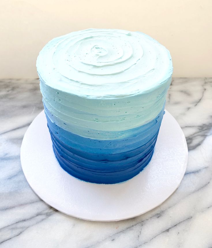 a blue and white cake sitting on top of a plate