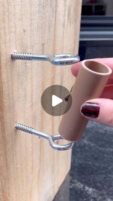 a person is holding onto a wooden door handle with two screws attached to it