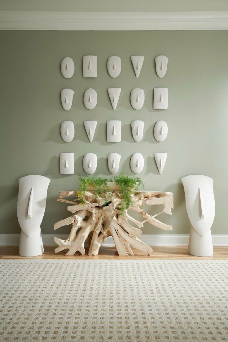 there is a table made out of driftwood and letters on the wall behind it