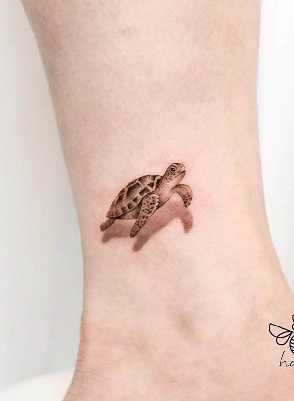 a small tattoo of a turtle on the side of a woman's leg,