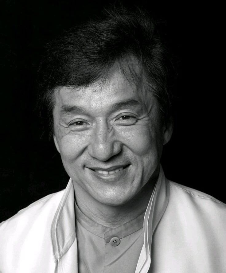 a black and white photo of a man smiling