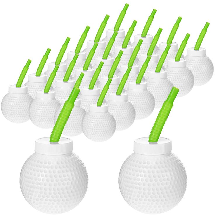 a bunch of white golf balls with green tees