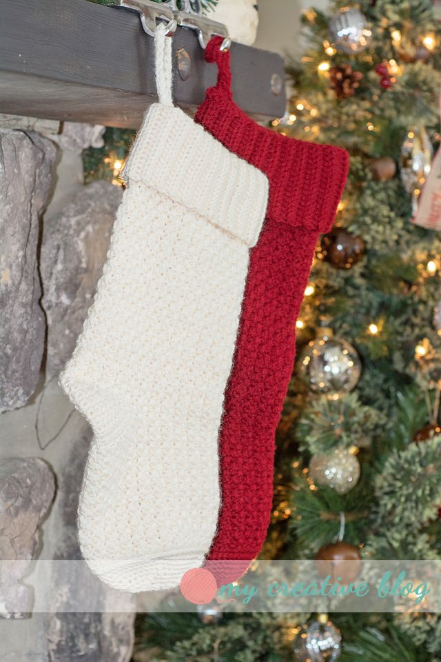 a knitted christmas stocking hanging from a fireplace mantle next to a decorated christmas tree