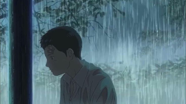 a man standing in front of a window next to a forest filled with raindrops