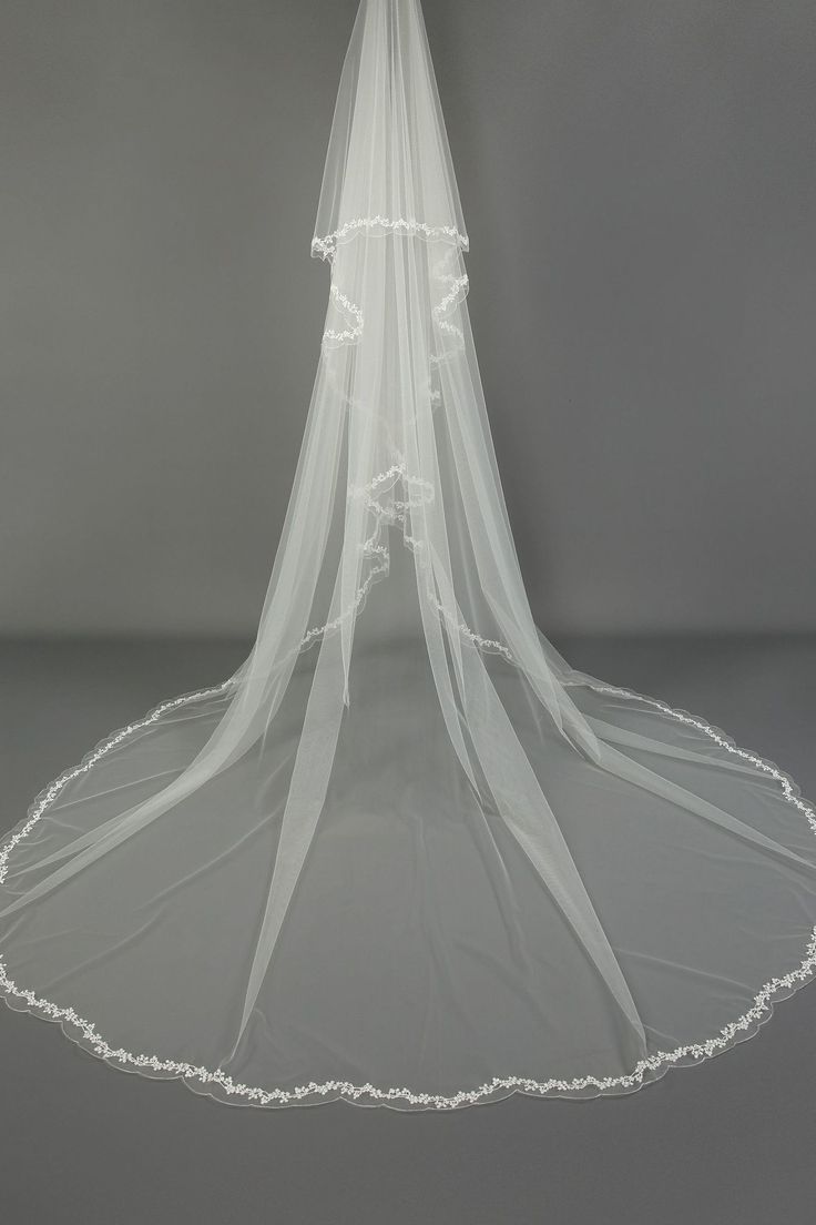 a white veil is hanging from the ceiling in front of a gray background with hearts on it