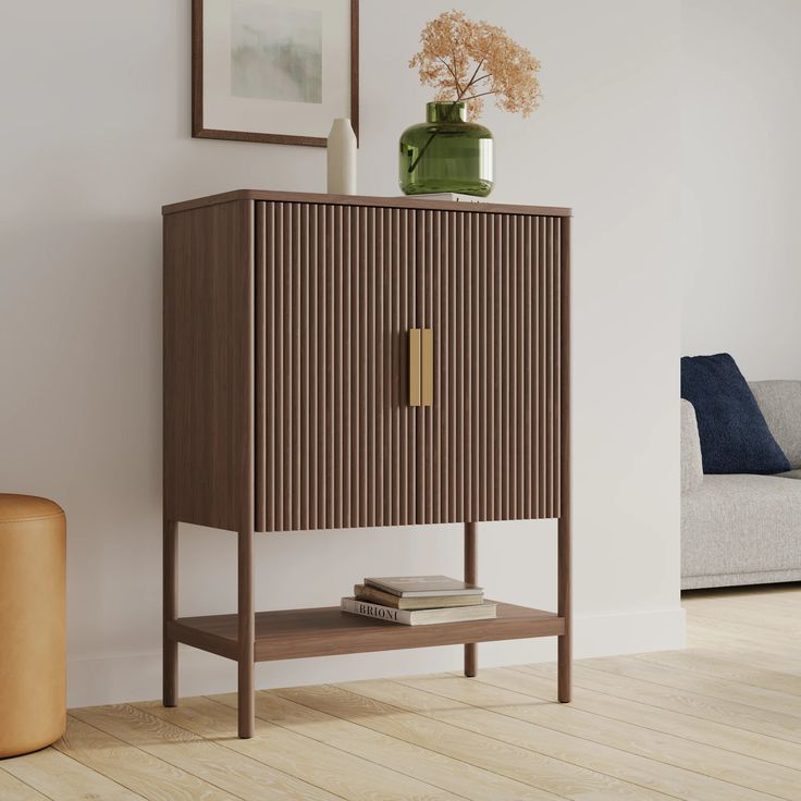 a brown cabinet sitting next to a white couch