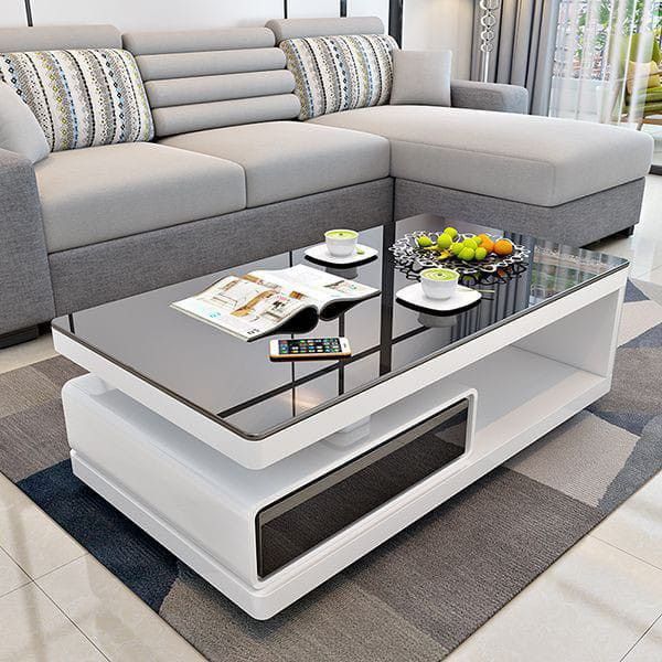 a living room with a couch, coffee table and television on top of the tv stand