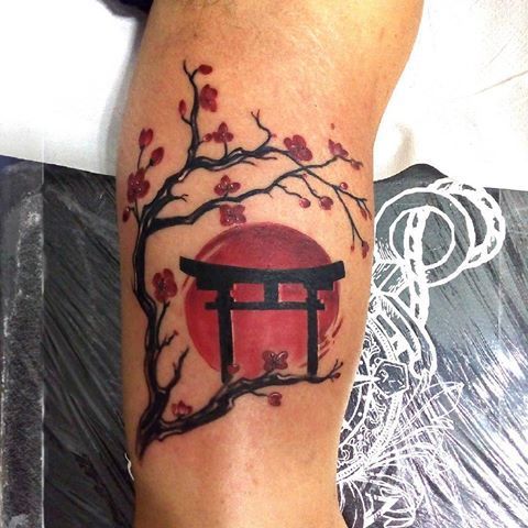 a person with a tattoo on their leg that has a red and black japanese lantern