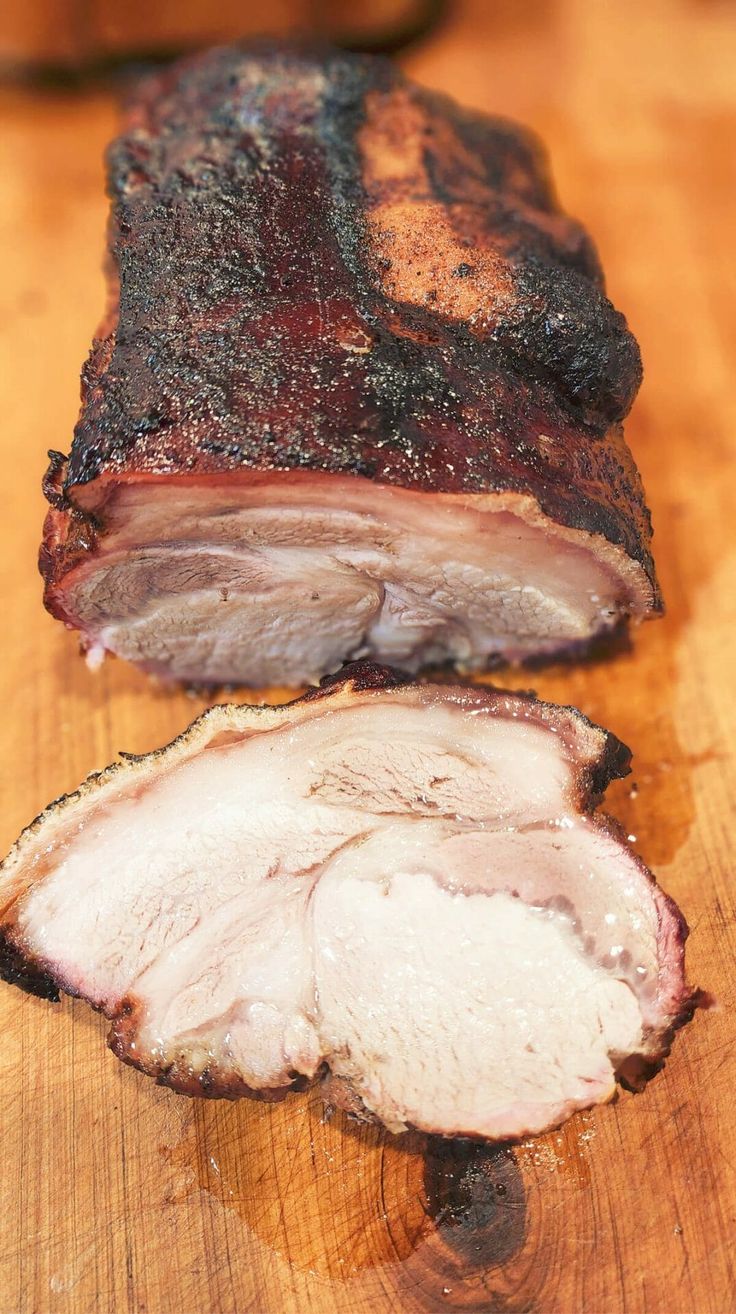 a piece of meat sitting on top of a wooden cutting board