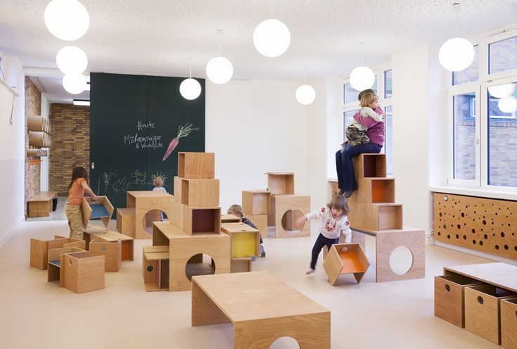 children playing with wooden blocks in a playroom