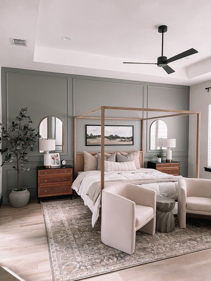 a bedroom with gray walls and white furniture