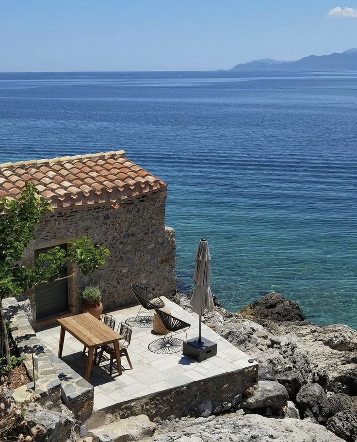 an outdoor dining area overlooking the ocean