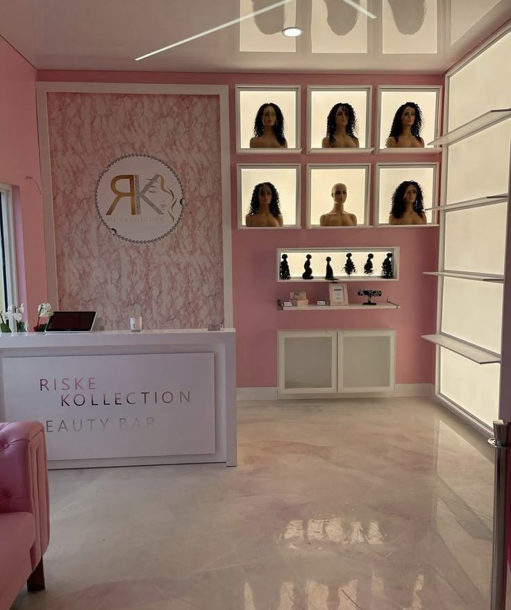 the inside of a beauty salon with pink walls