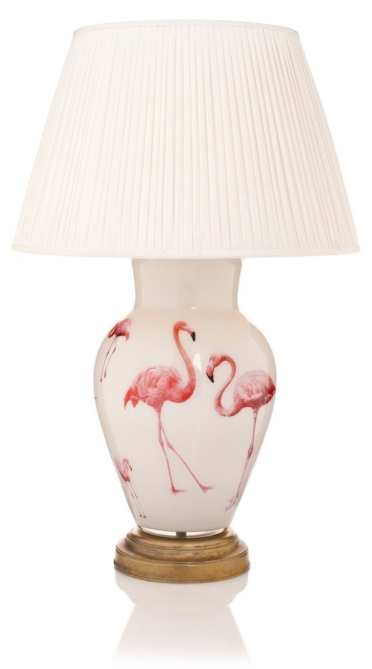 a white lamp with pink flamingos on it