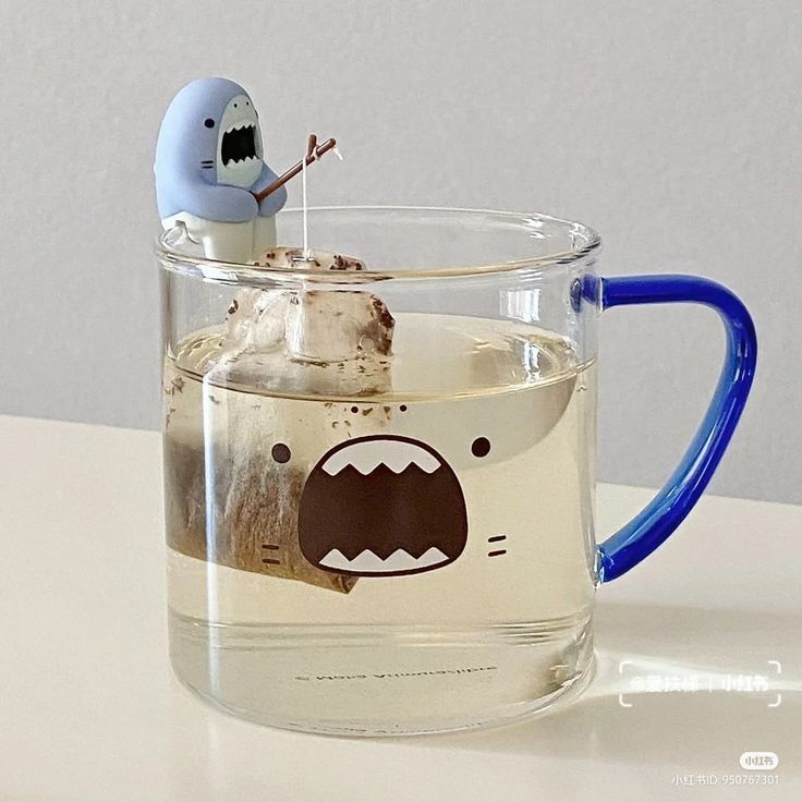 a glass mug with a cartoon character in it