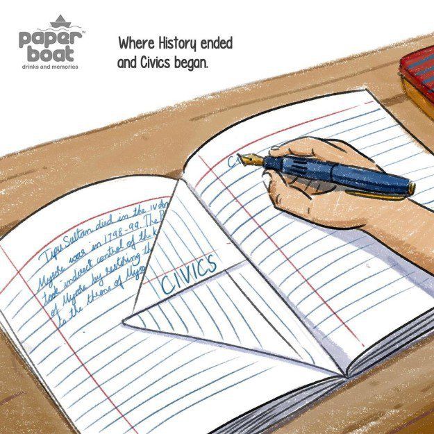 a hand holding a pen writing on top of an open book