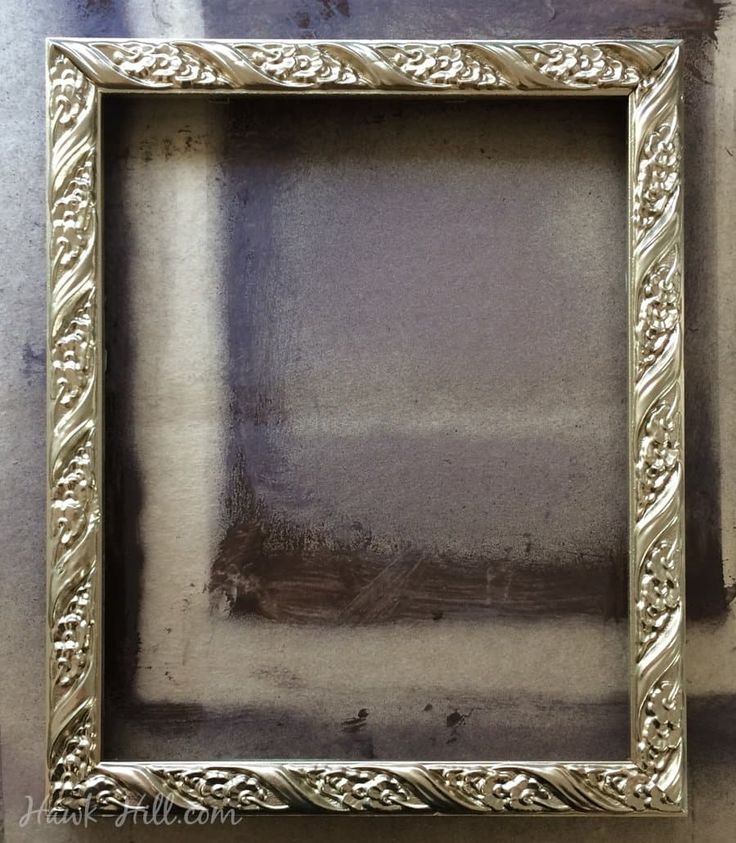 an ornate silver frame hanging on the wall