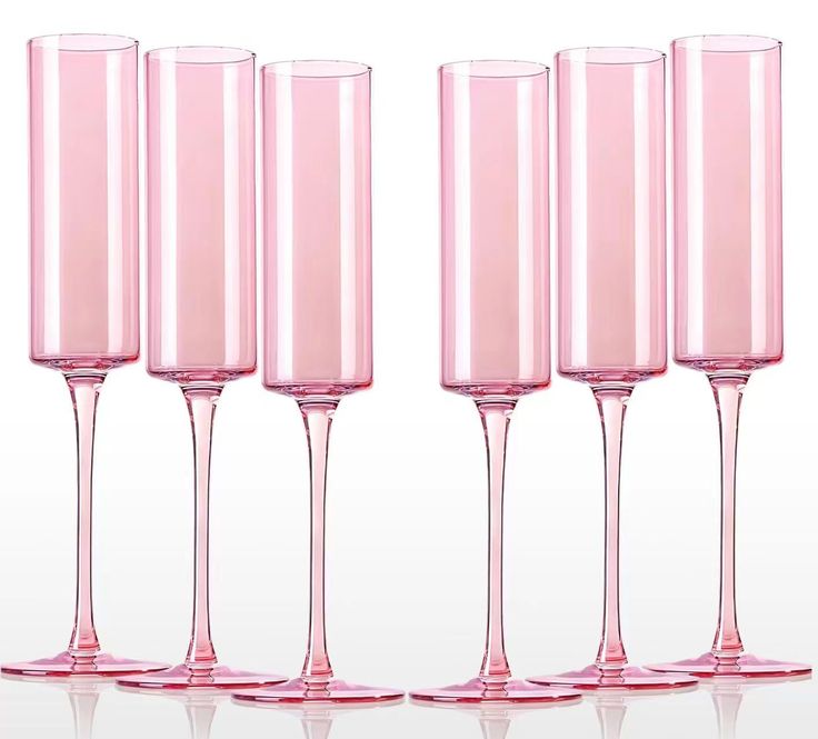 four pink wine glasses lined up in a row