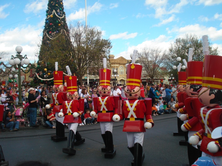 some people in red uniforms are marching down the street