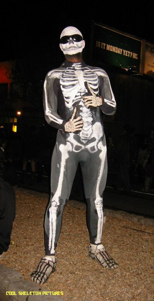 a skeleton costume is standing in the street