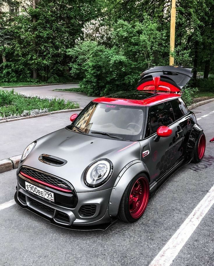 a small car parked on the street with its hood open