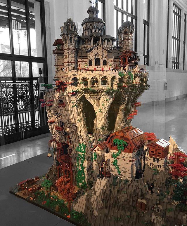 a large model of a castle made out of legos on display in a building