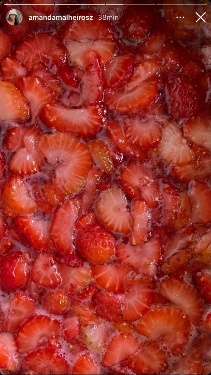 strawberries are being cooked in a pan on the stove top and then covered with water