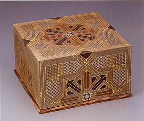 a wooden box with decorative designs on it