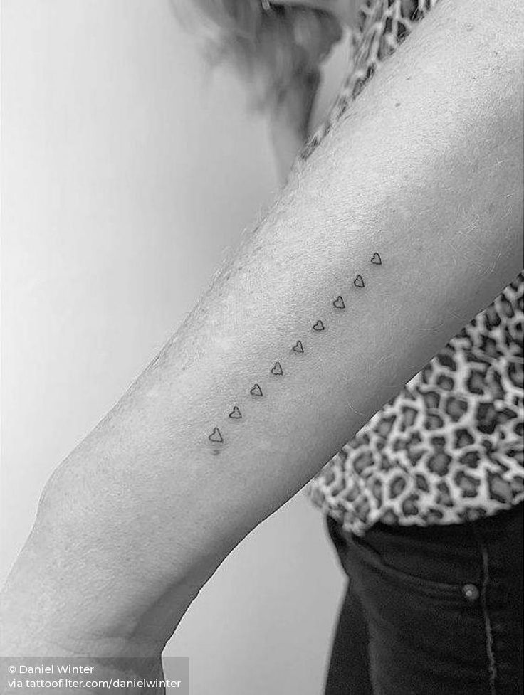 a woman's arm with the word love written in cursive letters on it