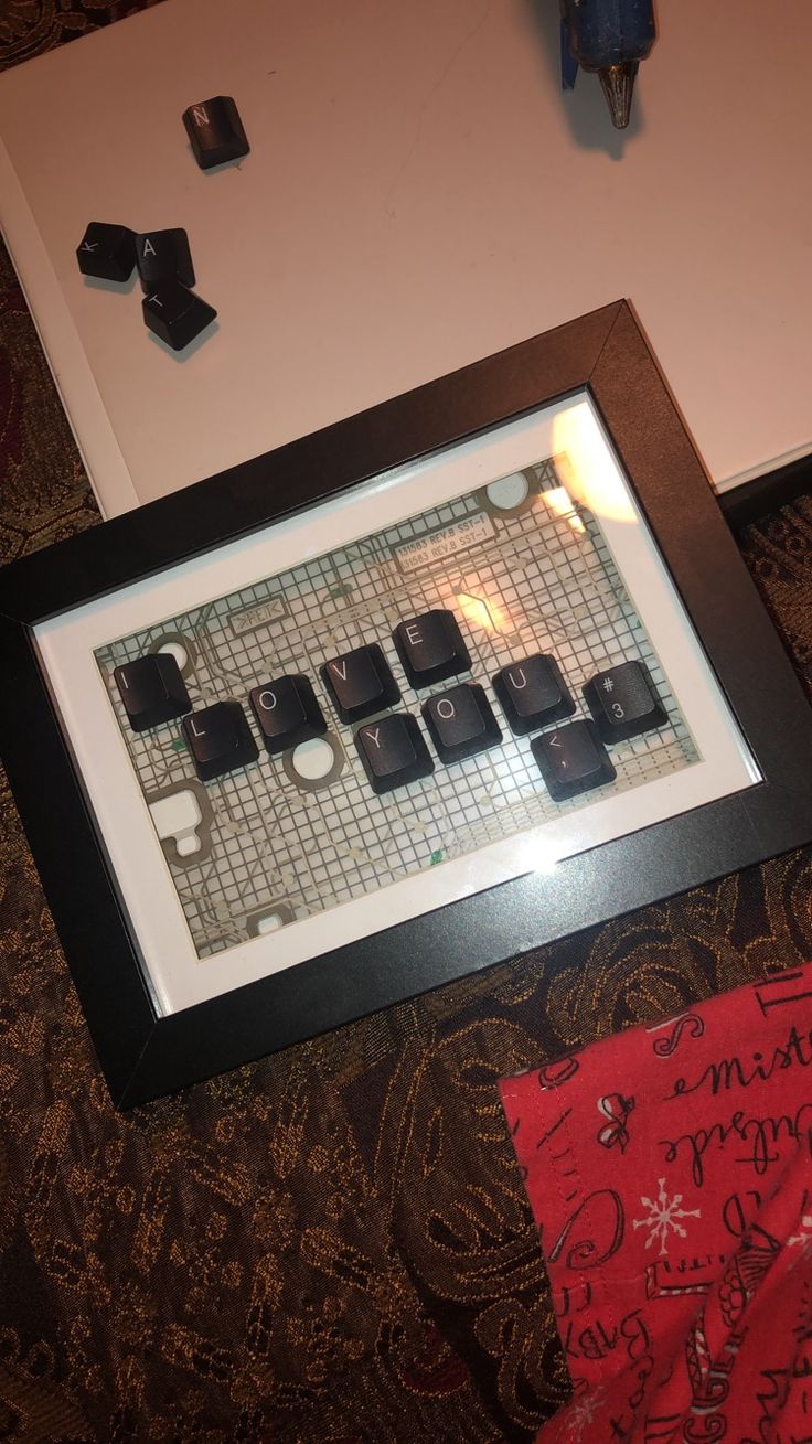 a computer keyboard sitting on top of a table next to a mouse pad and pen