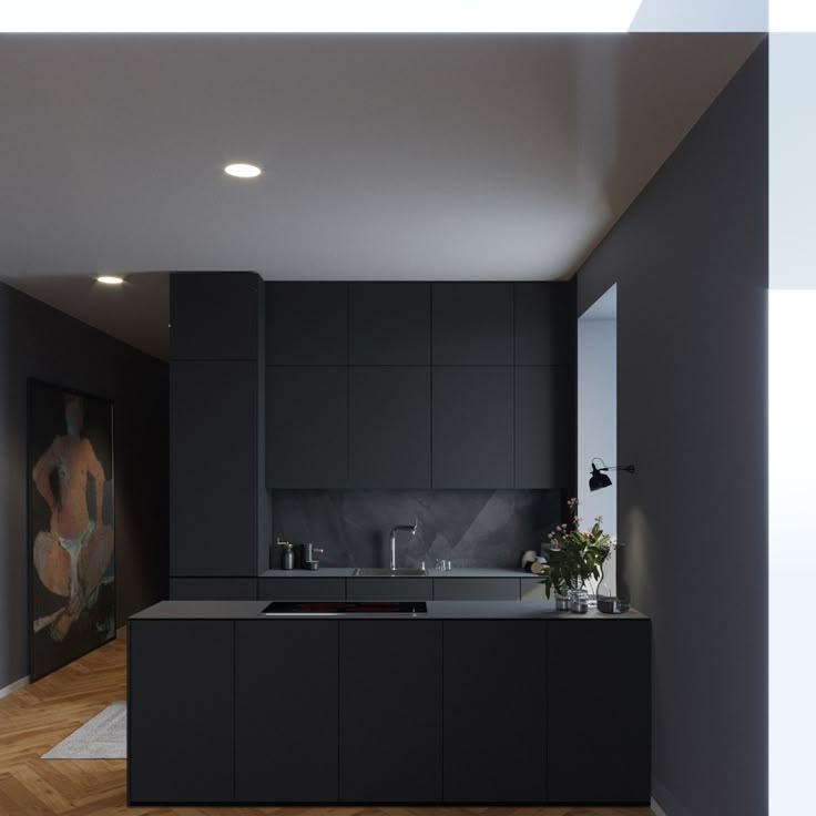 a modern kitchen with black cabinets and wood floors