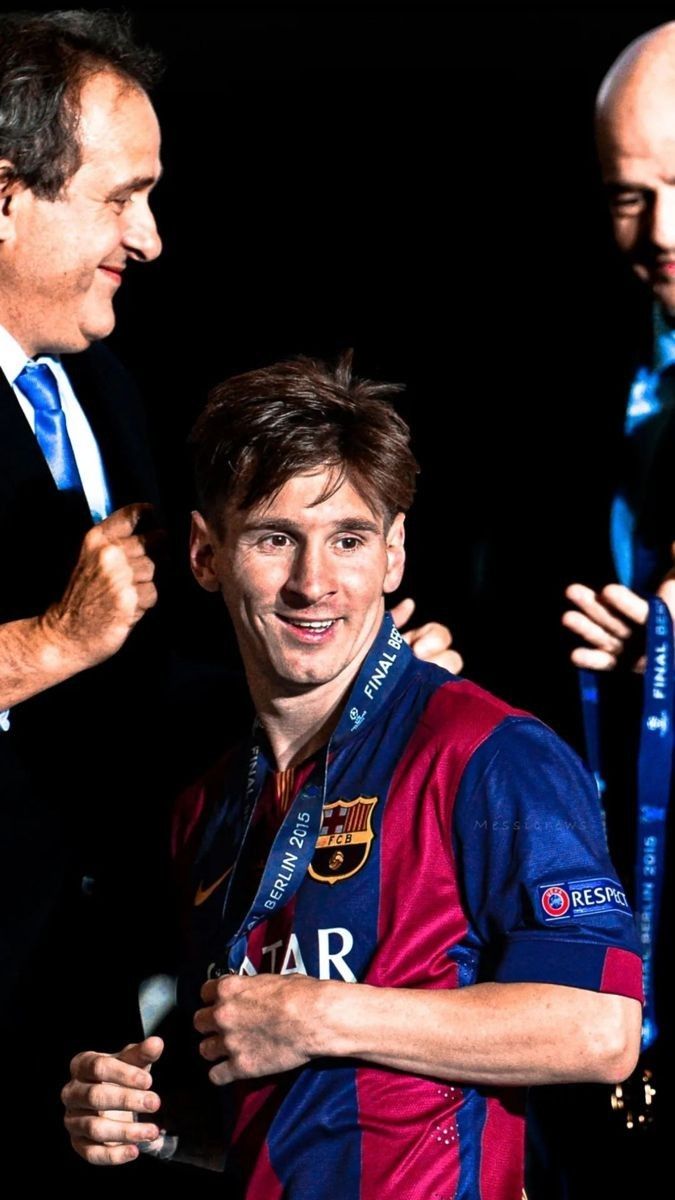 two men standing next to each other in front of a man with a blue tie