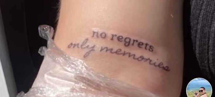 a person with a tattoo on their arm that says no regents are my memories